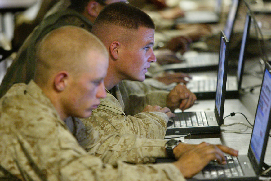 US marines from the First Battalion, 5th Marines, Bravo Company, browse the internet at camp Mercury 25 April 2004 in the restive city of Fallujah. The latest casualties brought to 717 the American military death toll since the US-led invasion of Iraq in March last year, including 519 killed in action, most of them fighting against insurgents. AFP PHOTO/Nicolas ASFOURI