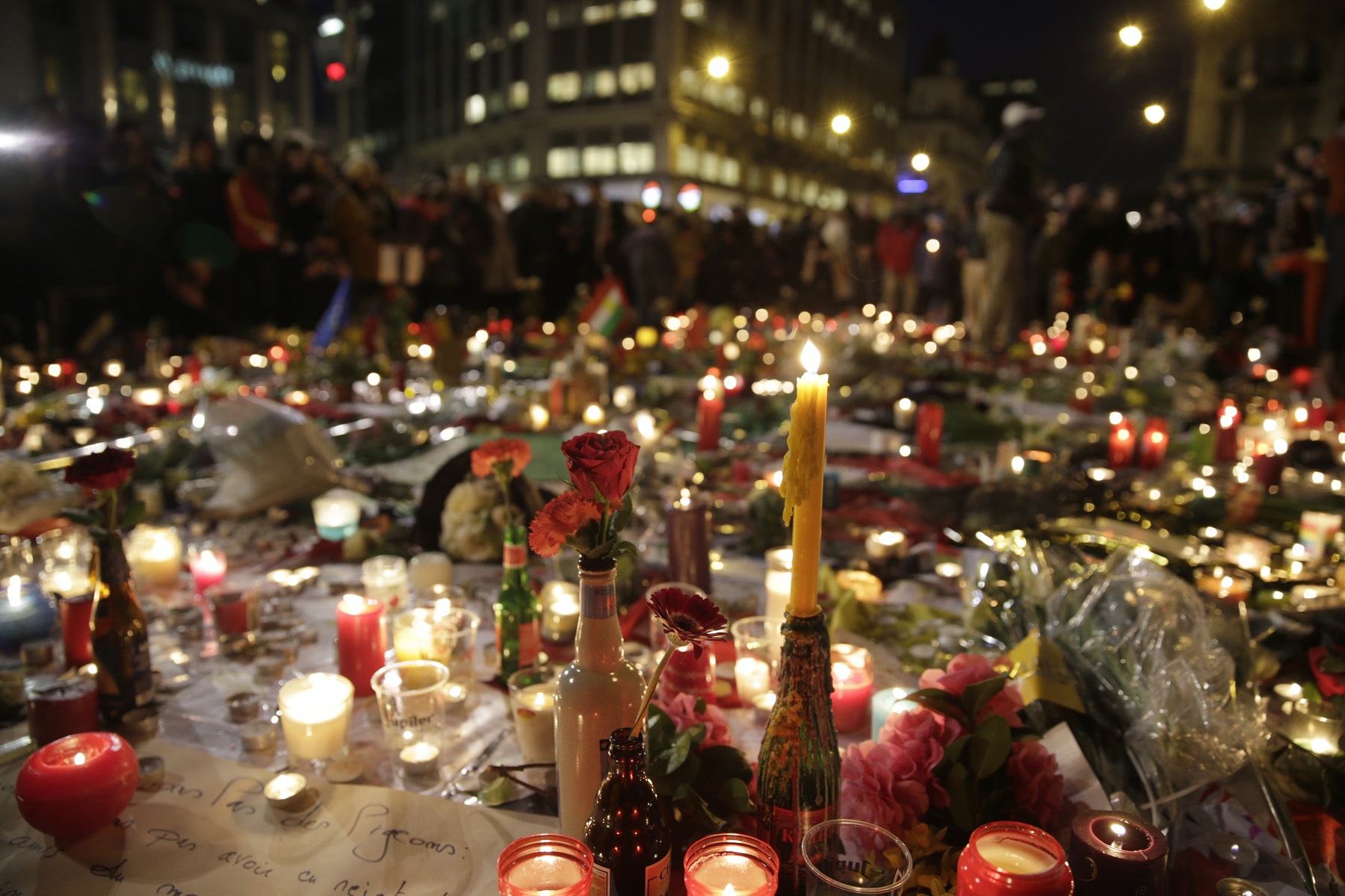 Flowers and candles are pictured as people gather at a makeshift memorial on the Place de la Bourse (Beursplein) in Brussels on March 23, 2016, a day after a triple bomb attack, which responsibility was claimed by the Islamic State group, left 31 dead and hundreds injured in the Belgian capital. World leaders united in condemning the carnage in Brussels and vowed to combat terrorism, after Islamic State bombers killed 31 people in a strike at the symbolic heart of the EU. AFP PHOTO / KENZO TRIBOUILLARD / AFP / KENZO TRIBOUILLARD