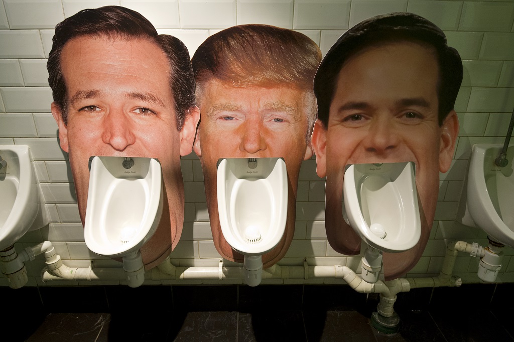 Cardboard cut outs of the faces of three candidates for the Republican nomination for the 2016 US Presidential election (L-R) Ted Cruz, Donald Trump and Marco Rubio, are seen set up on urinals in a pub in London on March 1, 2016 as part of an informal poll for customers to log which they dislike the most. Part of the satirical television show The Last Leg, customers at the pub are able to choose which urinal to use and then log their poll on a list on the wall afterwards. / AFP / JUSTIN TALLIS