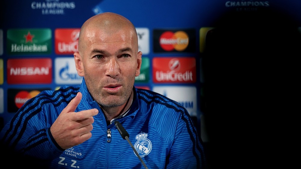 Real Madrid's French headcoach Zinedine Zidane gestures during a press conference at the Volkswagen Arena on the eve of the UEFA Champions League quarter-final, first-leg football match between VfL Wolfsburg and Real Madrid on April 5, 2016 in Wolfsburg, central Germany.  / AFP PHOTO / Ronny Hartmann