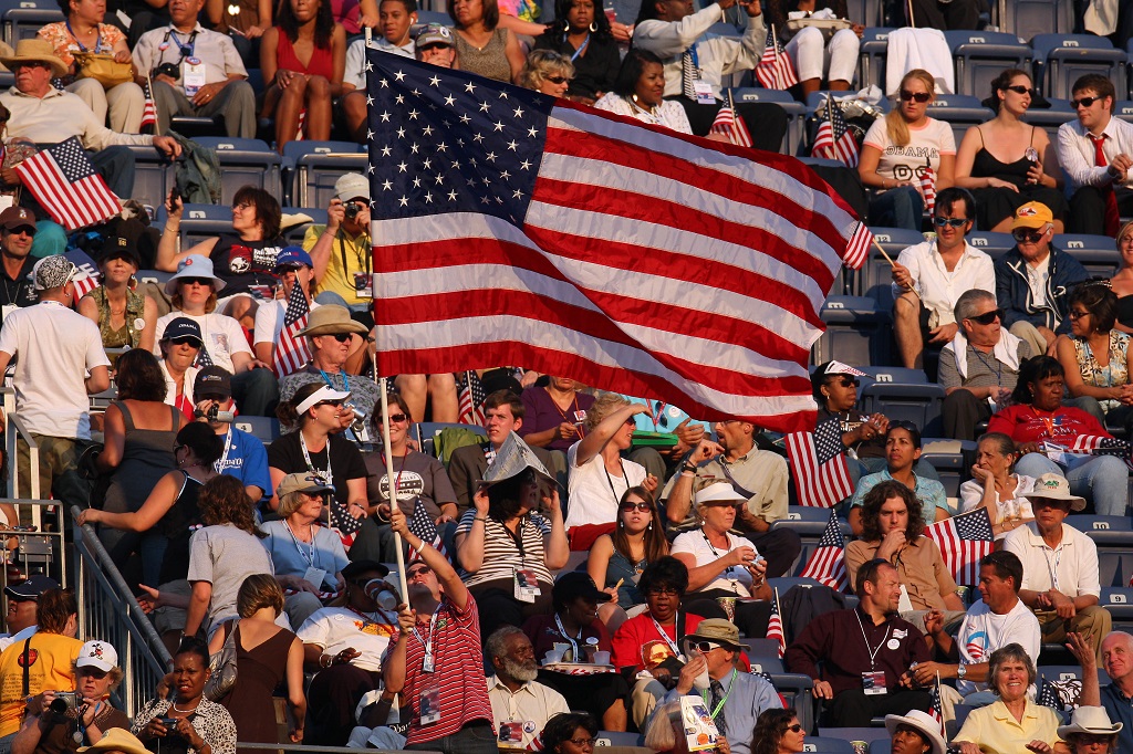 UNITED STATES - AUGUST 28: An attendee waves a large U.S. flag on day four of the Democratic National Convention (DNC) at Invesco Field at Mile High in Denver, Colorado, U.S., on Thursday, Aug. 28, 2008. Senator Barack Obama of Illinois will accept his party's nomination for Democratic presidential candidate during his speech at the stadium tonight. (Photo by Daniel Acker/Bloomberg via Getty Images)