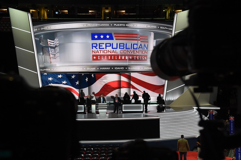 Workers prepare the stage before the opening of the Republican National Convention on July 18, 2016 in Cleveland, Ohio. Thousands of delegates descend on a tightly secured Cleveland arena for the opening of the Republican National Convention, with Donald Trump's wife playing character witness as the tough-talking mogul seeks to lock up his party's presidential nomination. / AFP PHOTO / Robyn BECK