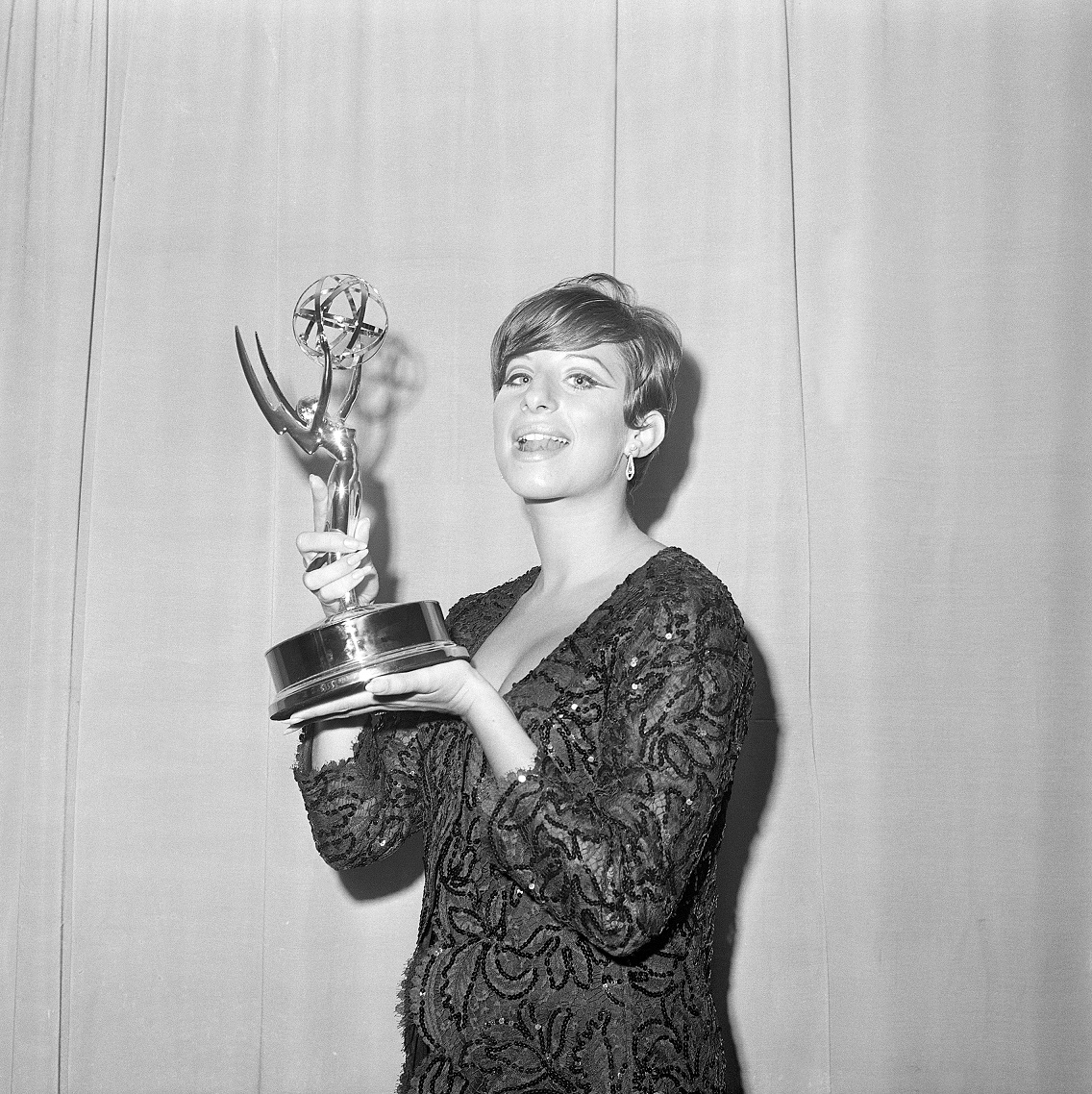(Original Caption) 9/12/1965-A radiant Barbara Streisand is shown holding the Emmy award she won for outstanding achievement presented to her here late September 12 at television's Emmy Awards. Other top winners were Dick van Dyke, Lynn Fontaine and Leonard Bernstein. Filed 9/13/1965.