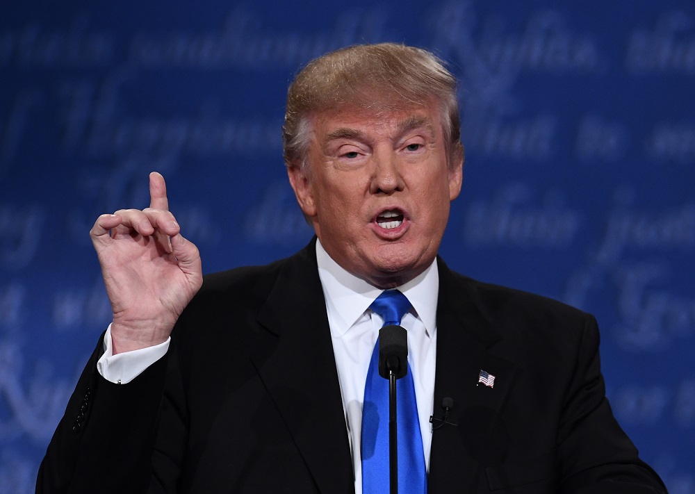 Republican nominee Donald Trump gestures during the first presidential debate at Hofstra University in Hempstead, New York on September 26, 2016. / AFP PHOTO / Jewel SAMAD