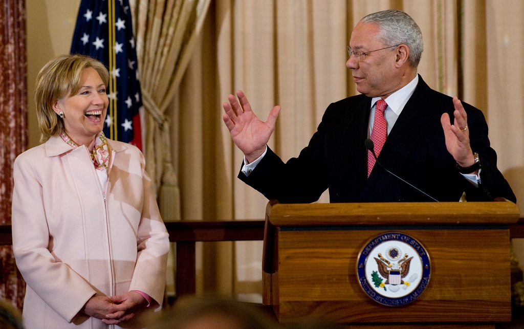 Former US Secretary of State Colin Powell speaks alongside US Secretary of State Hillary Clinton during the unveiling of Powell's official State Department portrait in the Benjamin Franklin Room at the State Department in Washington, DC, on December 7, 2009. Powell served as Secretary of State from 2001-2005 under former US President George W. Bush. AFP PHOTO / Saul LOEB / AFP PHOTO / SAUL LOEB