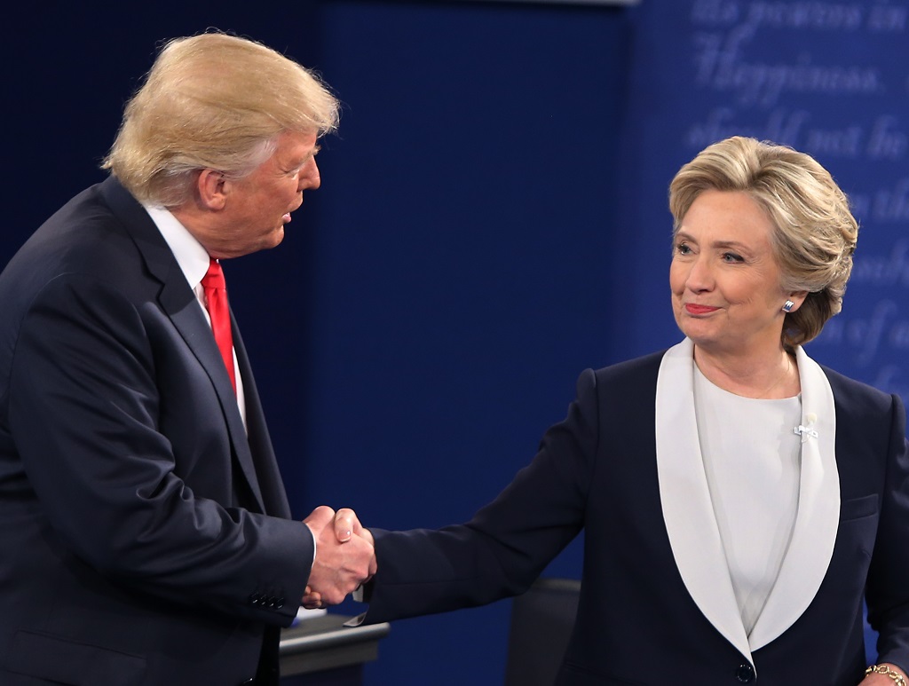 US Democratic presidential candidate Hillary Clinton and US Republican presidential candidate Donald Trump shake hands at the end of the second presidential debate at Washington University in St. Louis, Missouri, on October 9, 2016. / AFP PHOTO / Tasos Katopodis