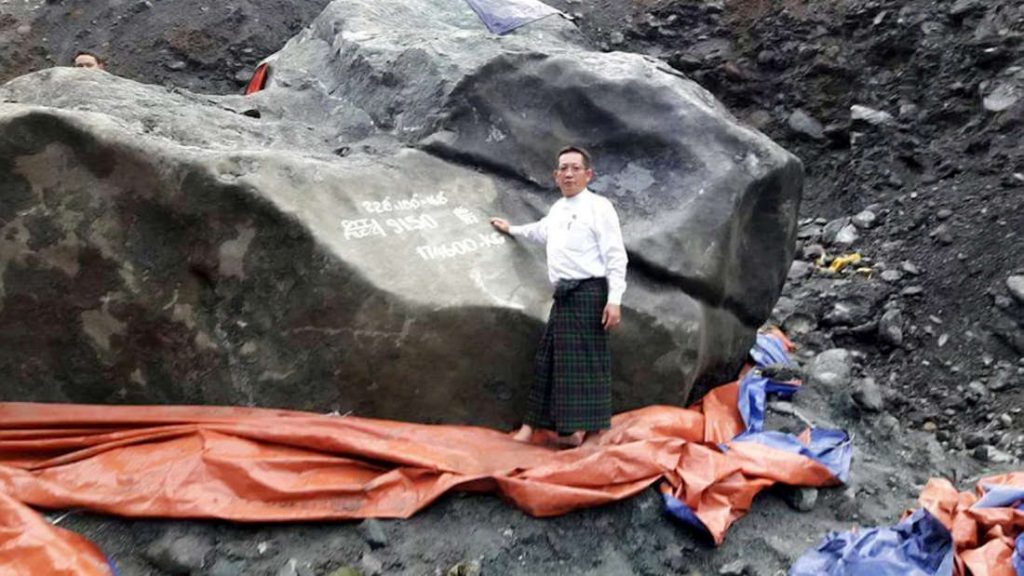 Stunned miners thought they had won the lottery when they struck this enormous boulder - the world's most valuable piece of JADE worth $175m. See SWNS story SWJADE. Workers were excavating rare gems at a remote mine in Kachin State, Burma, when they stumbled across the huge jadeite rock on Thursday afternoon. It weighs a staggering 175 tonnes (174,600kg) , measures 9ft high, 18ft long and 18ft wide. Remarkable pictures show local politician U Tint Soe standing next to the giant gem as it towers above him. The rock - which will appear its distinctive green once cleaned - is second only in size to the a carved statue at the Jade Buddha Palace in China which weighs 260 tonnes.