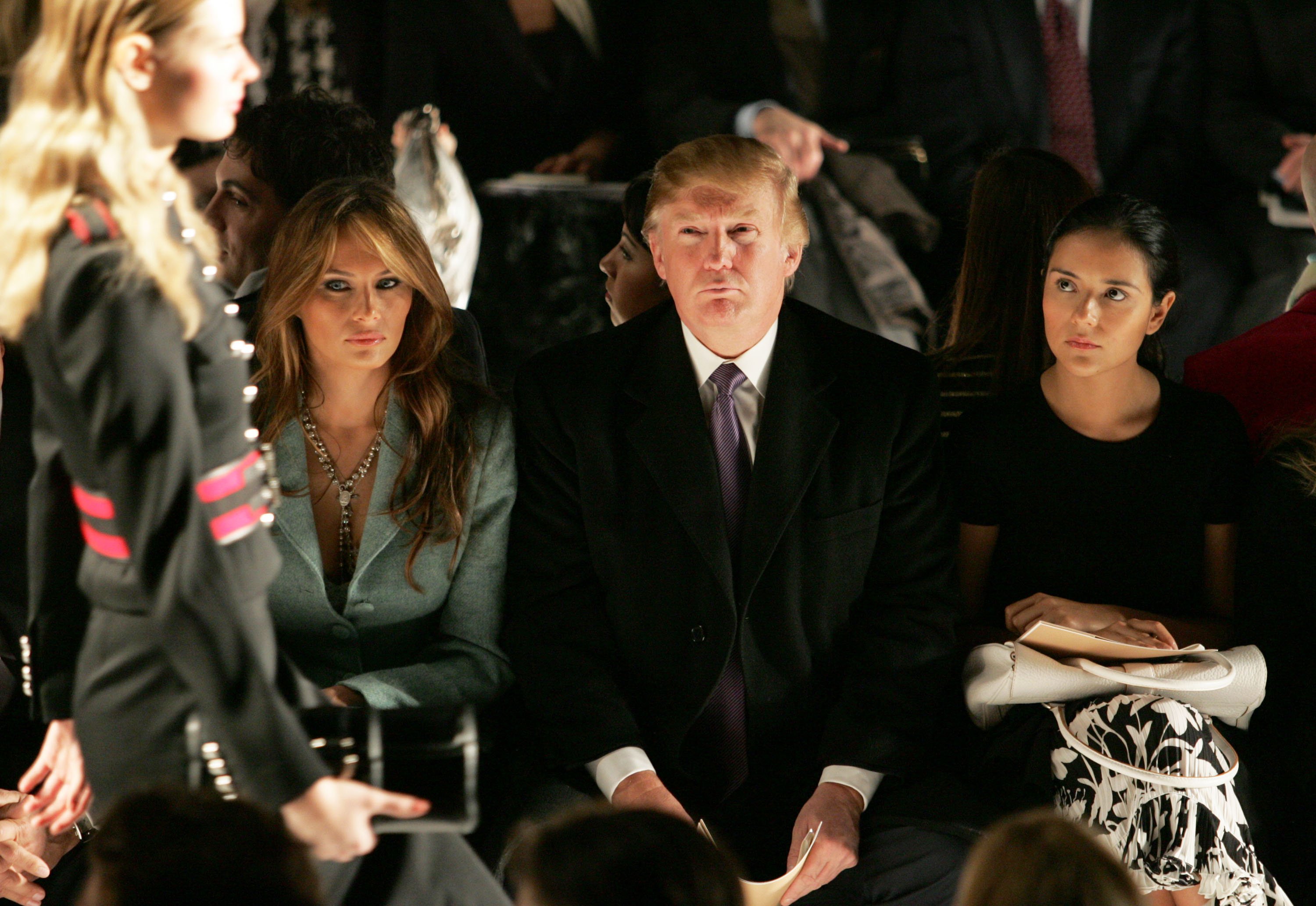 NEW YORK, NY - FEBRUARY 09: Donald Trump, his wife Melania Trump and Catalina Sandino Moreno attend the Michael Kors Fall 2005 fashion show during the Olympus Fashion Week at Bryant Park February 9, 2005 in New York City. (Photo by Peter Kramer/Getty Images)