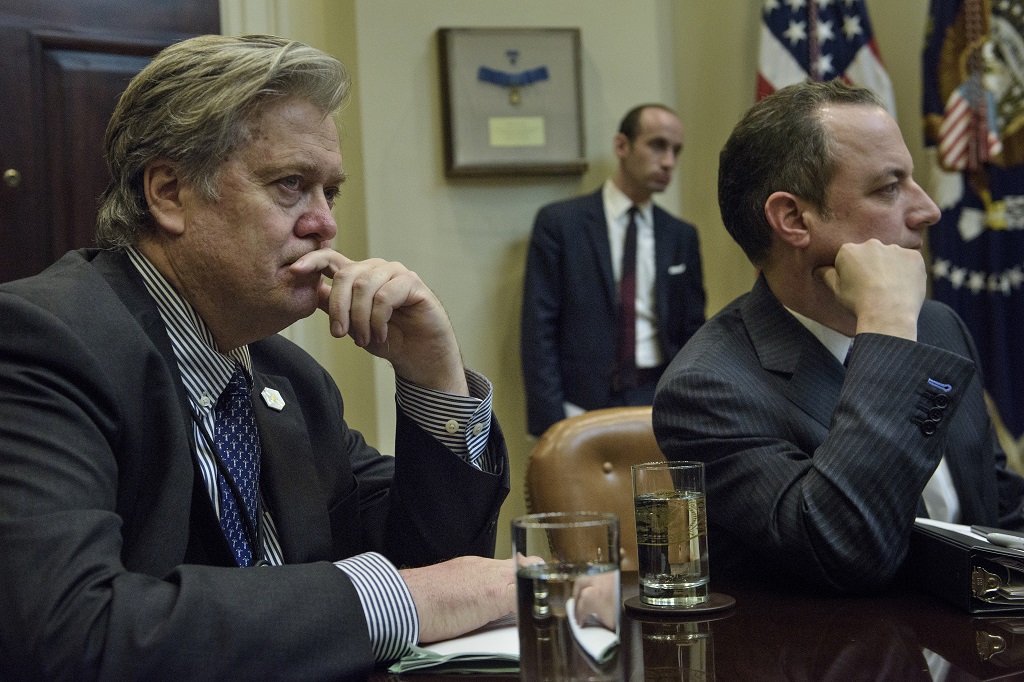 From left: Trump advisor Steve Bannon, advisor Stephen Miller and White House Chief of Staff Reince Priebus listen while US President Donald Trump speaks at the beginning of a meeting with lawmakers in the Roosevelt Room of the White House February 2, 2017 in Washington, DC. / AFP PHOTO / Brendan Smialowski
