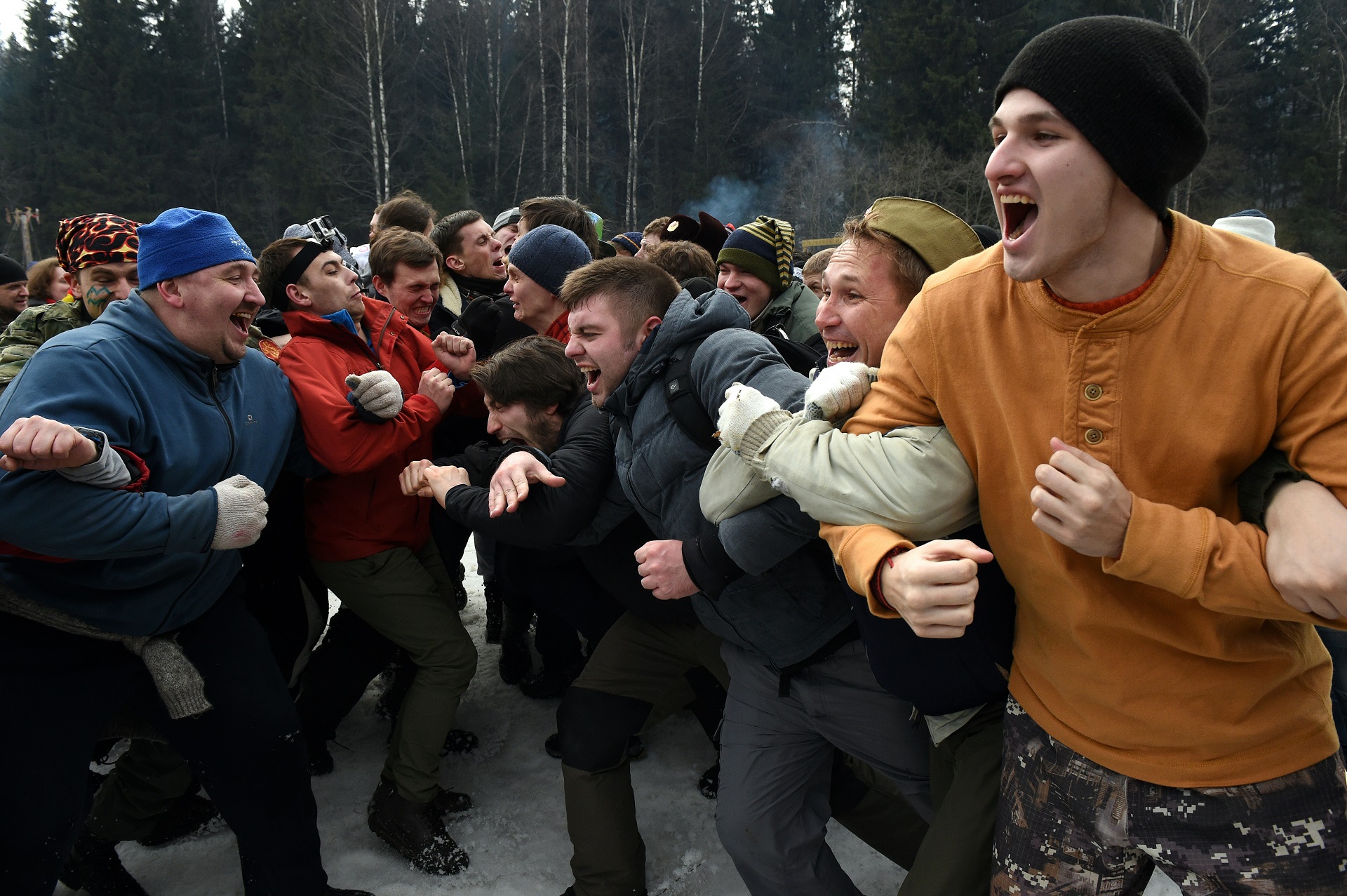 Men take part in a traditional fight close to the village of Abramtsevo, 60 km north of Moscow on March 13, 2016, in celebration of Maslenitsa (Shrovetide), a farewell ceremony to winter. Shrovetide precedes the beginning of Lent, with each day of the week holding its own meaning. Shrove Sunday, also known as the Sunday of Forgiveness, is a day for asking forgiveness for the harm caused to other people intentionally or unintentionally. / AFP PHOTO / VASILY MAXIMOV