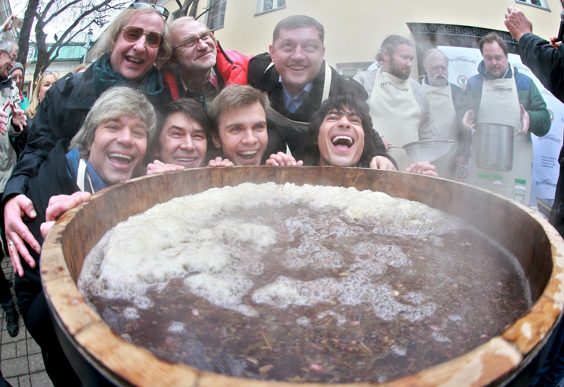 2805989 03/13/2016 First row, from left: Na-Na band members Slava Zherebkin, Vladimir Politov and Mikhail Semidyanov, with director Andrei Zhitinkin, second row left, during the event entitled 'Maslenitsa in Guinness World Records'. A giant portion of honey sbiten, an ancient Russian hot drink, was cooked in downtown Moscow. Anton Denisov/Sputnik