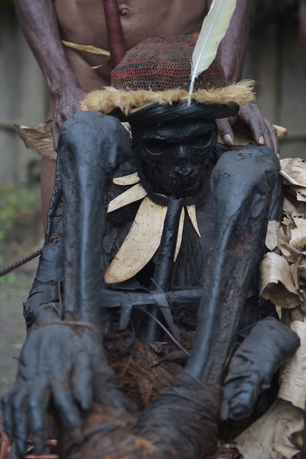 This photo taken on August 7, 2016 shows a mummy of the Dani tribe, Agat Mamete Mabel, being displayed in the village of Wogi in Wamena, the long-isolated home of the Dani tribe high in the Papuan central highlands. Despite smoked mummification being no longer practised for Dani tribes people, they still preserve a number of mummies, some a few hundred years old, as a symbol of their highest respects to their ancestors, which in recent years has attracted tourists from around the world. / AFP PHOTO / ADEK BERRY